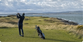Golfer overlooking the Isle of Man coast