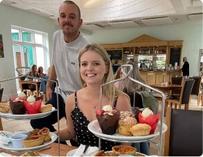 Couple enjoying drinks and food at a Ramsey café
